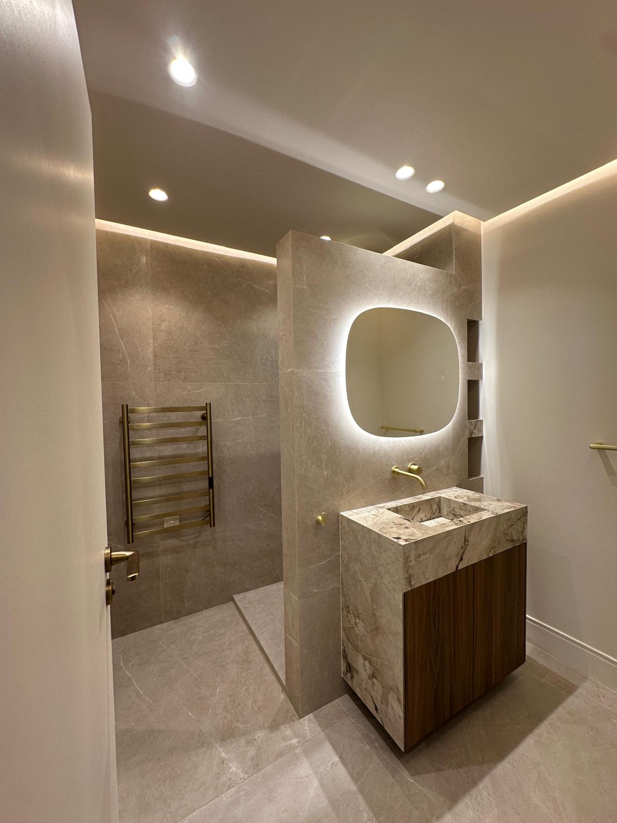 Rénovatoin d'un salle de bain ancienne dans une maison en salle de bain moderne avec du marbre noir